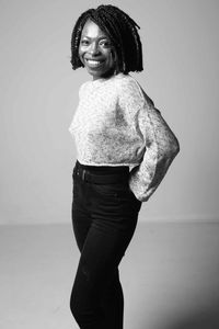 Portrait of smiling young woman against white background