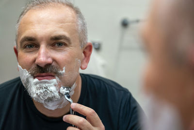 Close-up of man drinking water