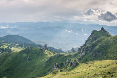 Scenic view of landscape and mountains against sky