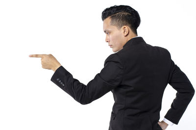 Side view of man looking away against white background