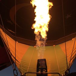 Low angle view of fire in hot air balloon against sky at night