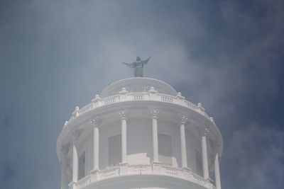 Low angle view of building against cloudy sky