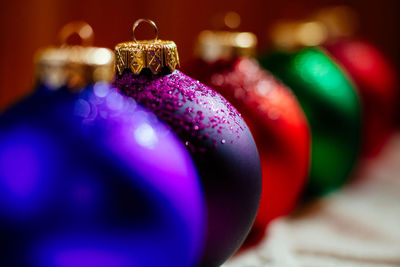 Close-up of colorful christmas decorations in row on table