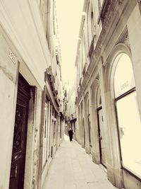 Man walking in corridor of building