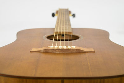 Close-up of guitar against white background