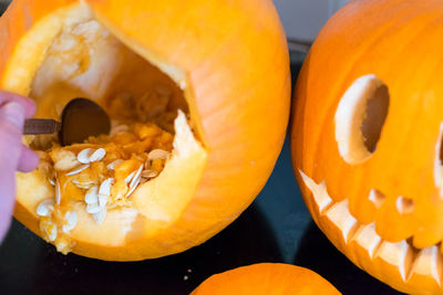 Cropped hand on person removing pumpkin seeds