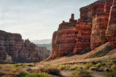 View of rock formations on landscape against sky