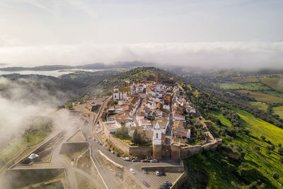 Monsaraz drone aerial view on the clouds in alentejo, portugal
