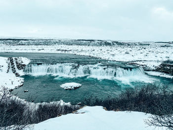 Aerial view of frozen sea against sky