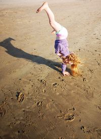 High angle view of girl on sand at beach