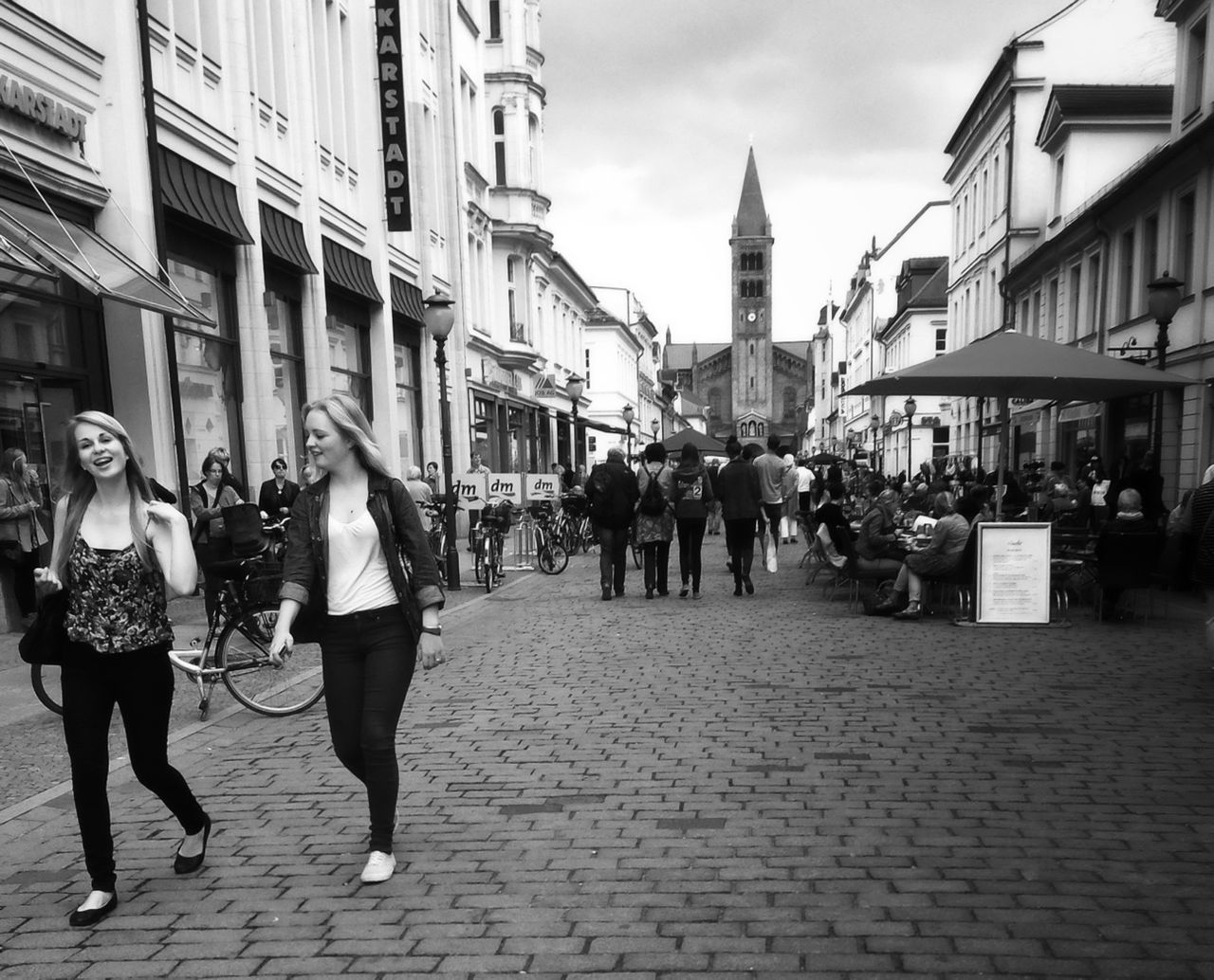 architecture, building exterior, built structure, walking, men, person, city, large group of people, street, lifestyles, city life, cobblestone, sky, travel destinations, religion, rear view, travel, leisure activity, place of worship