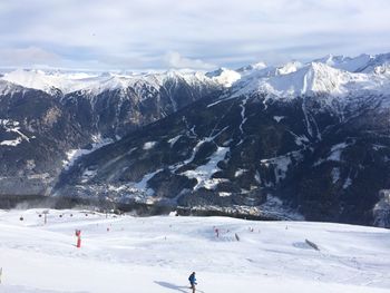 People skiing on snow covered landscape