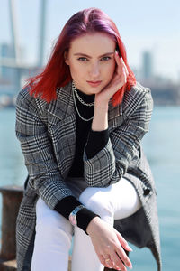 Portrait of young woman sitting outdoors