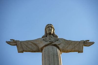 Low angle view of statue against clear blue sky