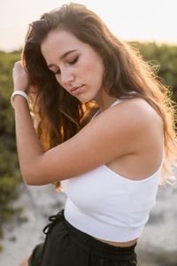 Thoughtful young woman standing outdoors