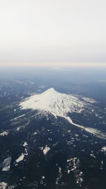 Aerial view of snowcapped mountain against sky