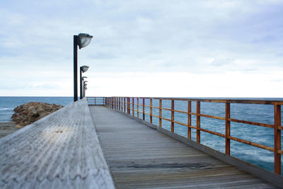 Pier over sea against sky