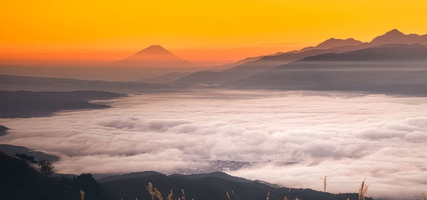 Scenic view of snowcapped mountains against sky during sunset