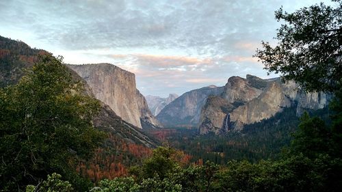 Scenic view of mountains against cloudy sky