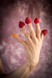 Close-up of hand holding strawberry