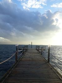 Pier over sea against sky