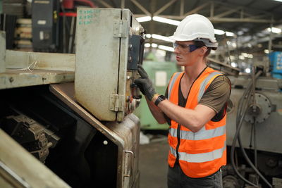 Young man working in factory