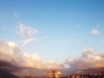 Buildings in city at sunset