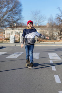 Portrait of boy standing on road