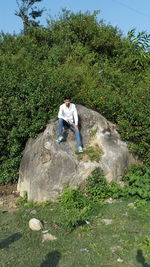 Full length of woman standing on rock