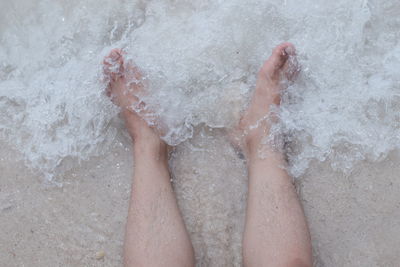 Low section of person feet in water