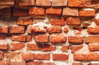 Damaged red brick wall. old building