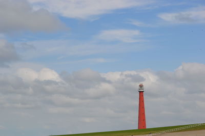 Low angle view of lighthouse against cloudy sky