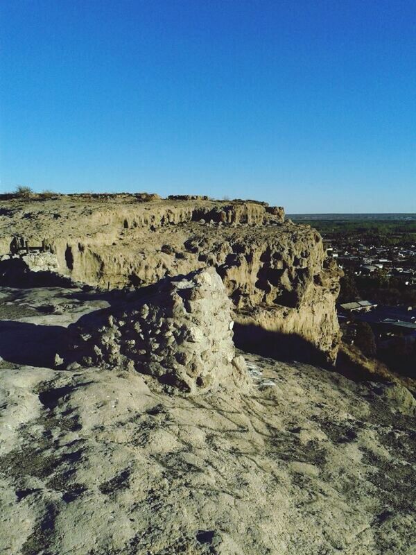 clear sky, copy space, blue, tranquility, tranquil scene, rock - object, scenics, water, nature, rock formation, beauty in nature, sea, rock, sunlight, day, outdoors, no people, idyllic, non-urban scene, rough