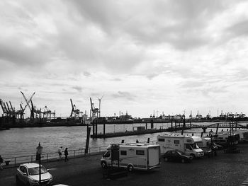 Harbor against cloudy sky