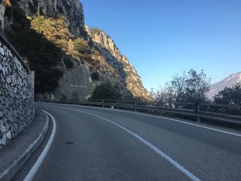 Road by mountain against clear sky