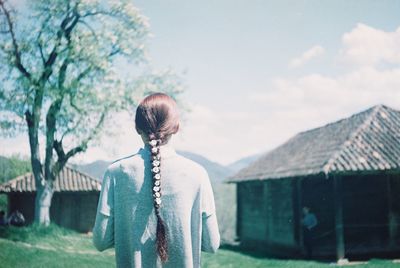 Rear view of woman standing against sky