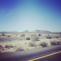 Scenic view of landscape against blue sky