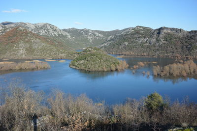 Scenic view of lake and mountains against sky