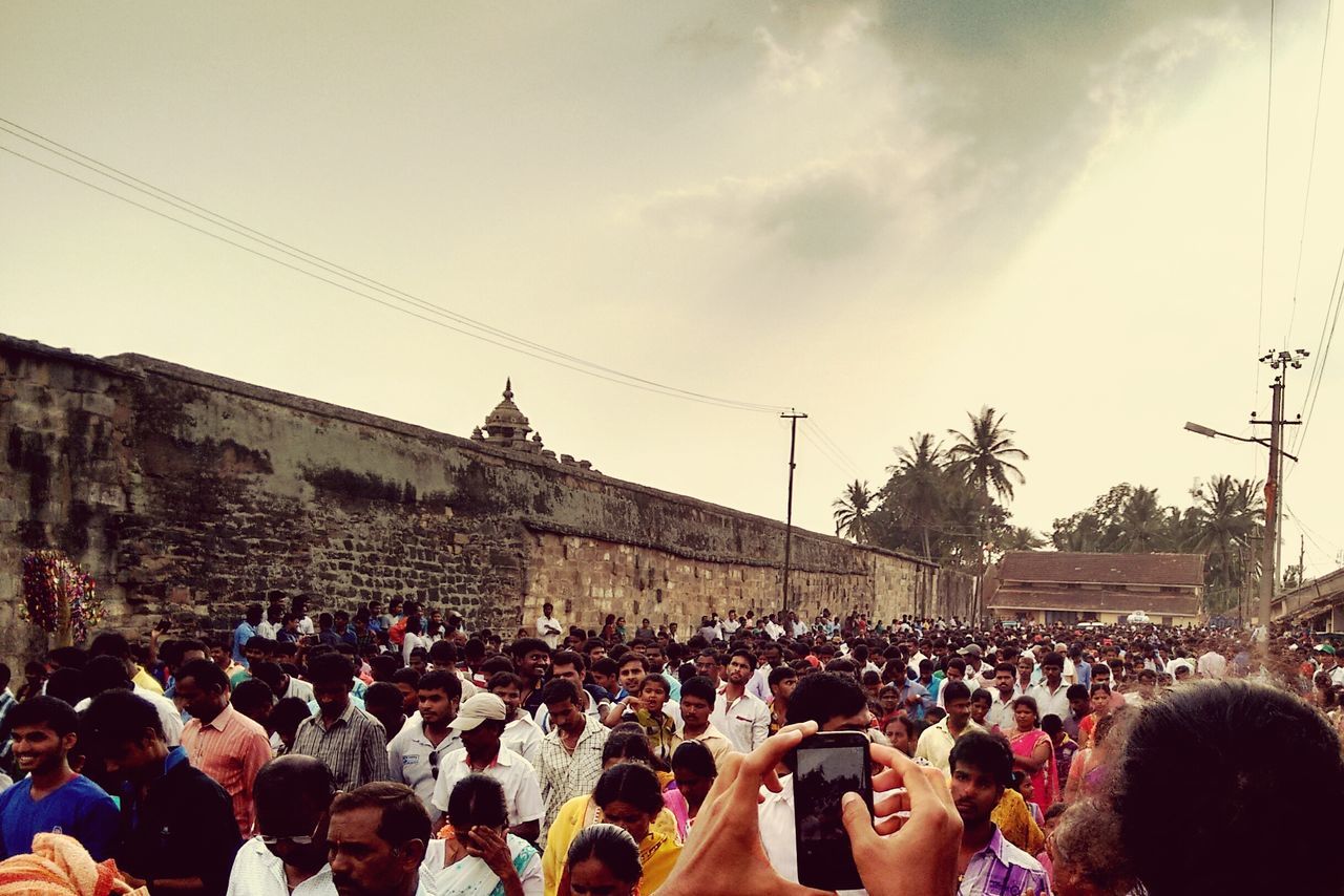 large group of people, crowd, person, lifestyles, men, architecture, built structure, building exterior, leisure activity, mixed age range, sky, crowded, city life, togetherness, city, religion, celebration, outdoors, street