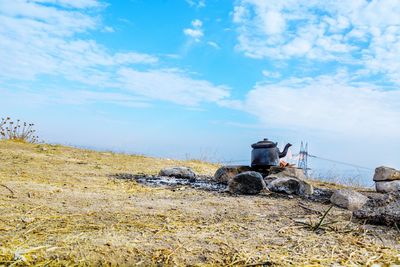 Abandoned building on field against sky