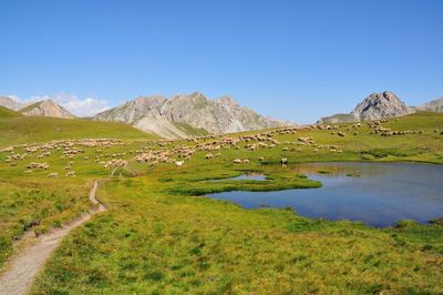 Scenic view of lake and mountains against sky