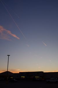 Silhouette airplane against sky during sunset