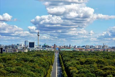 View of city buildings against cloudy sky