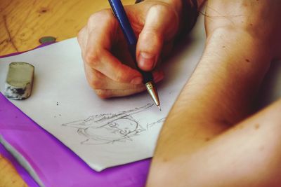 Close-up of woman making drawing on paper