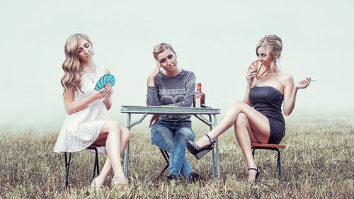 Young women sitting on chair
