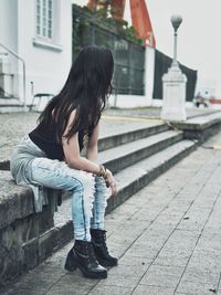 Full length of woman on sidewalk in city