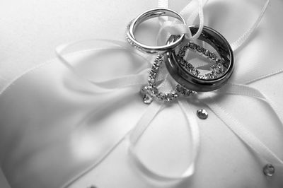 Close-up of wedding rings on cushion