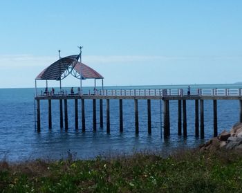 Pier over sea against clear sky