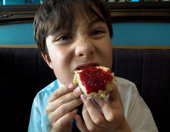 Close-up of boy eating breakfast at home