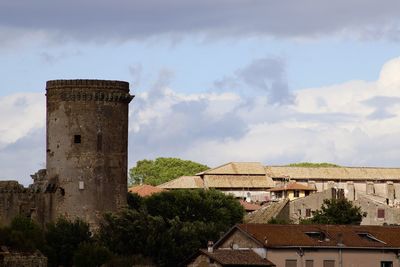 Tower of a castle and old buildings in a town nepi in italy